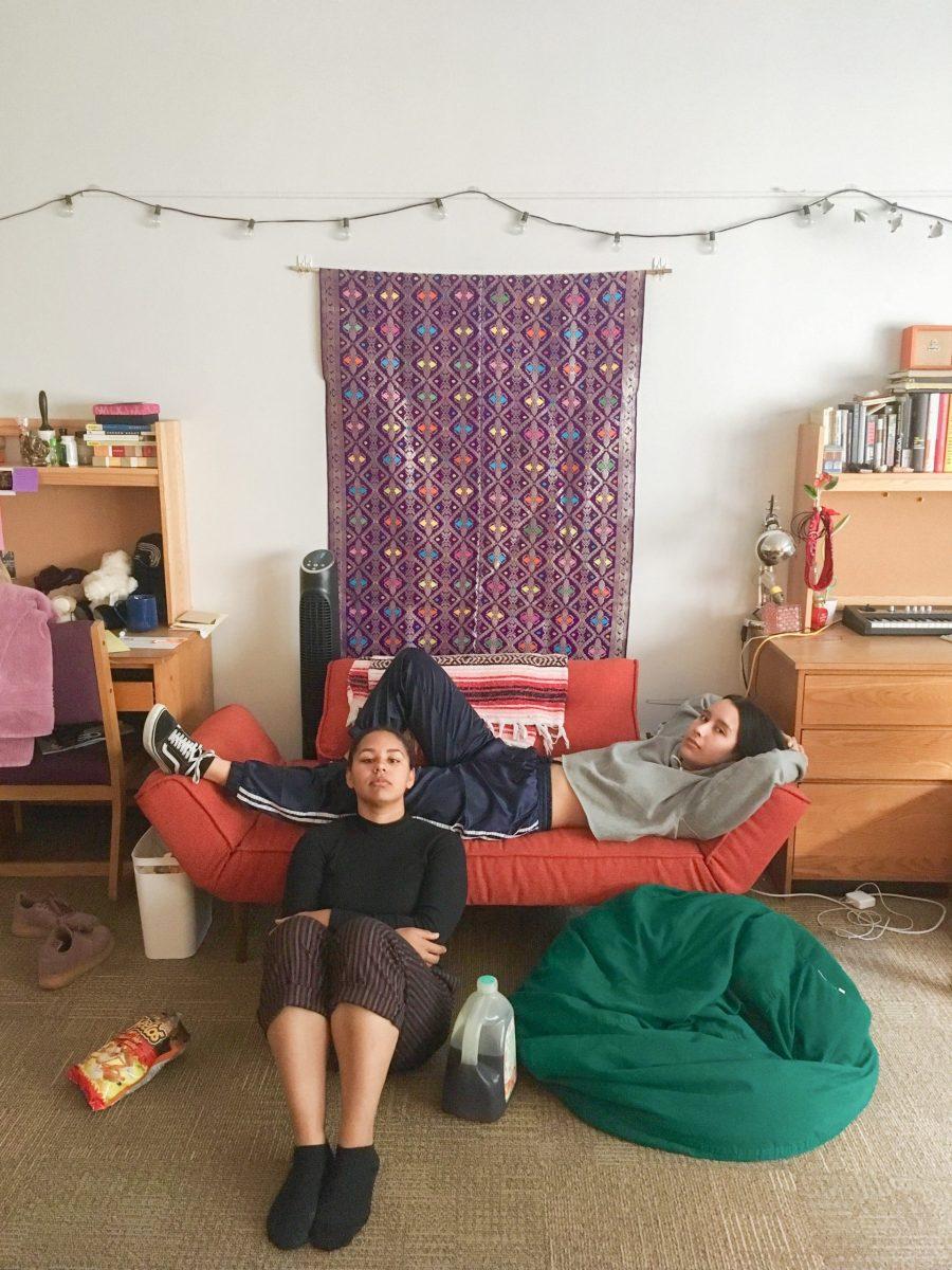 Natalia Granquist '21 and Selena Smith '21 lounging in a decorated dorm room in Rand Hall