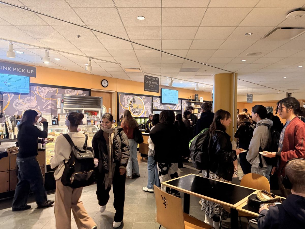 Students lining up in front of The Cage, a cafe that shares a space with the Mediterranean Bowl line during weekdays. 