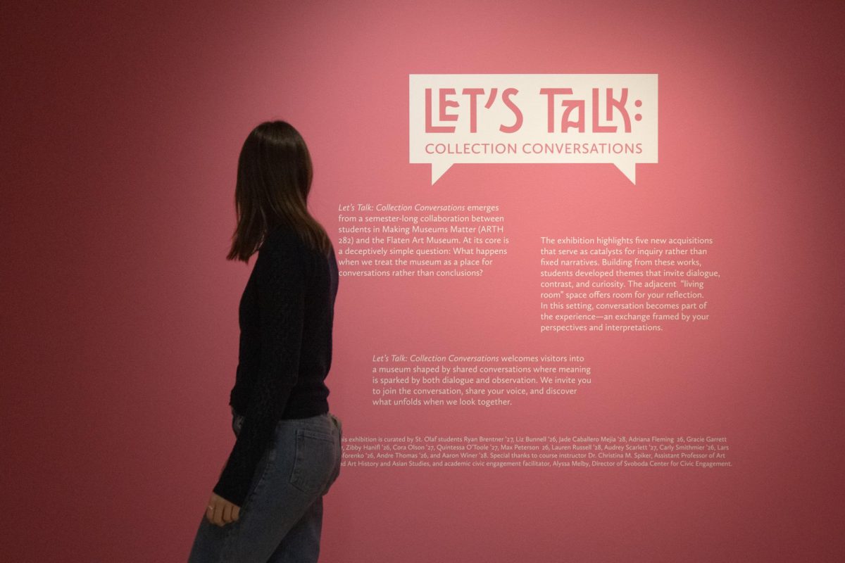 An attendee walks past the entrance to the exhibition. 